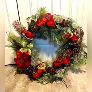 Christmas wreath with birds, poinsettias, cranberries, pine cones